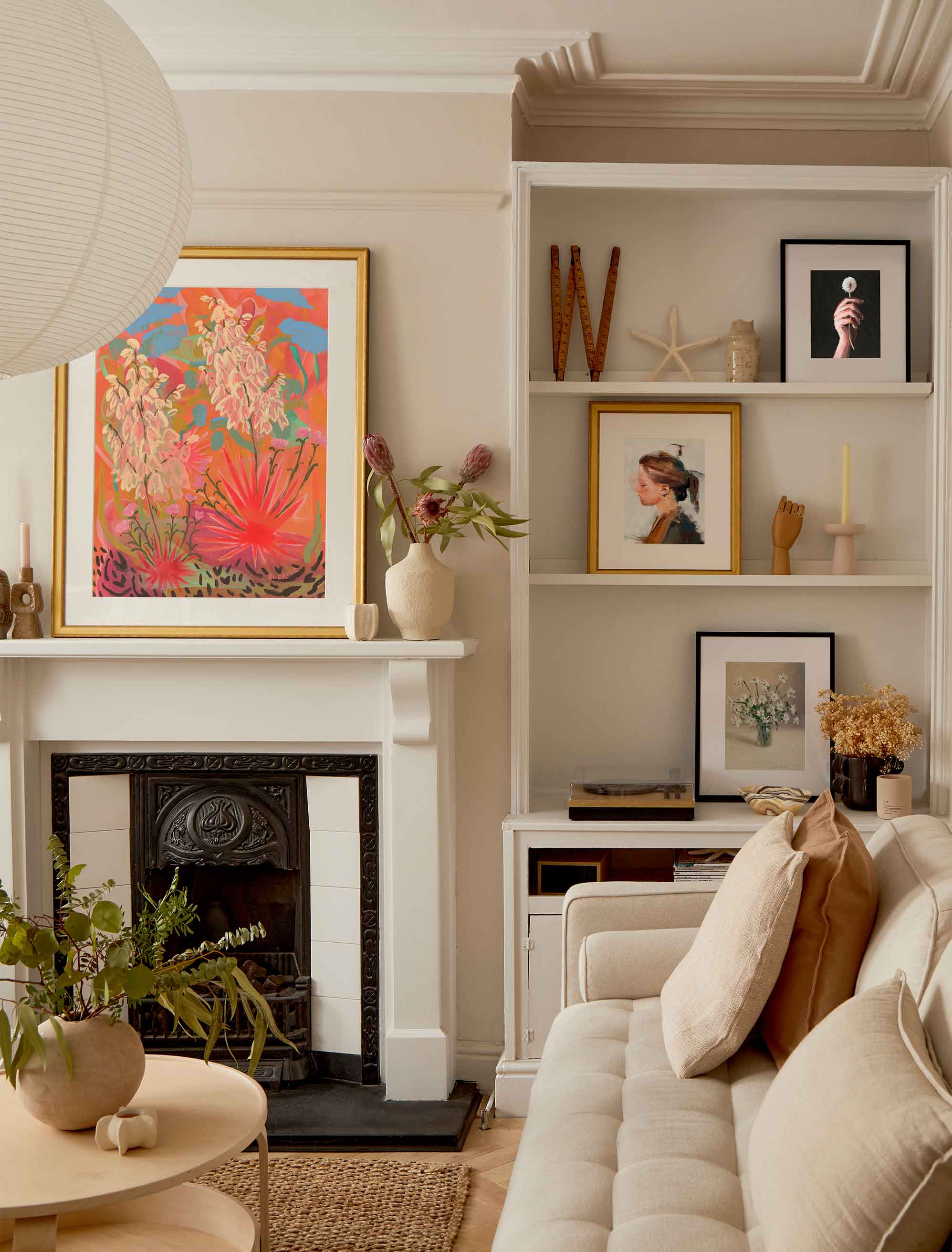 Art sprinkled across a living room can transform a space to a cozy oasis.&nbsp;
