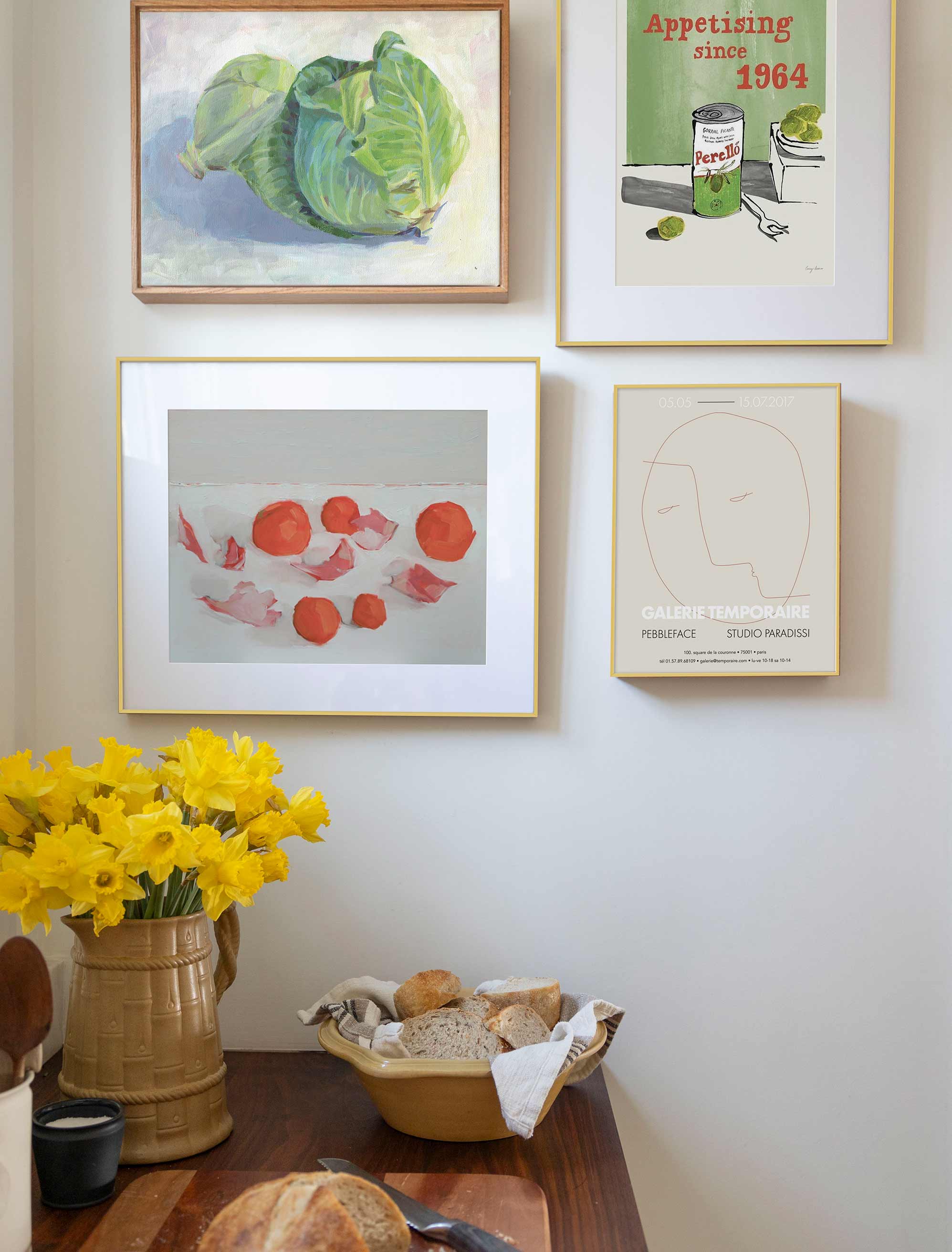 A well-planned kitchen gallery wall pairs the right art, size, and spacing to make the room feel warm and personal.