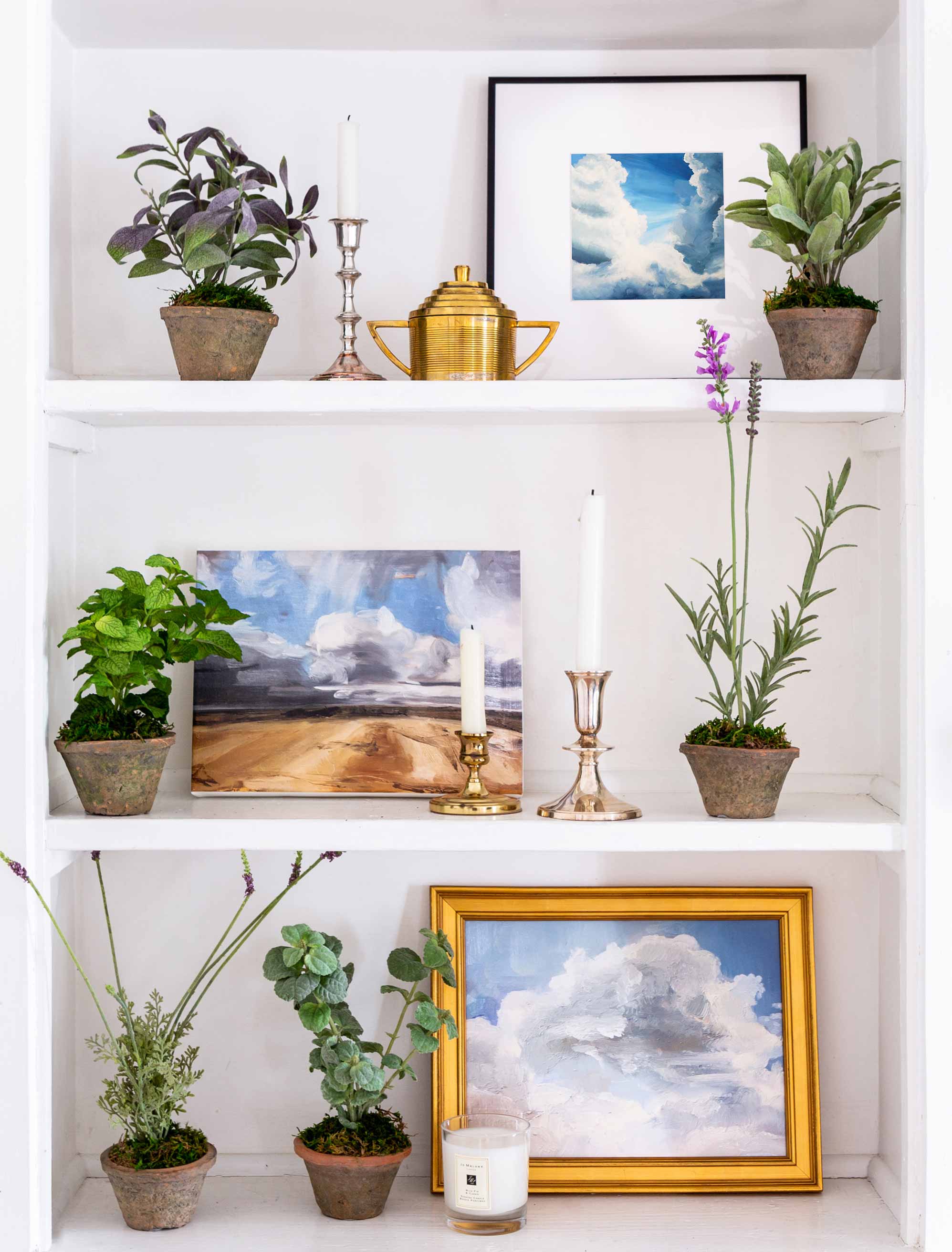 Cloud art prints nestled next to plants for the perfect shelfie.&nbsp;